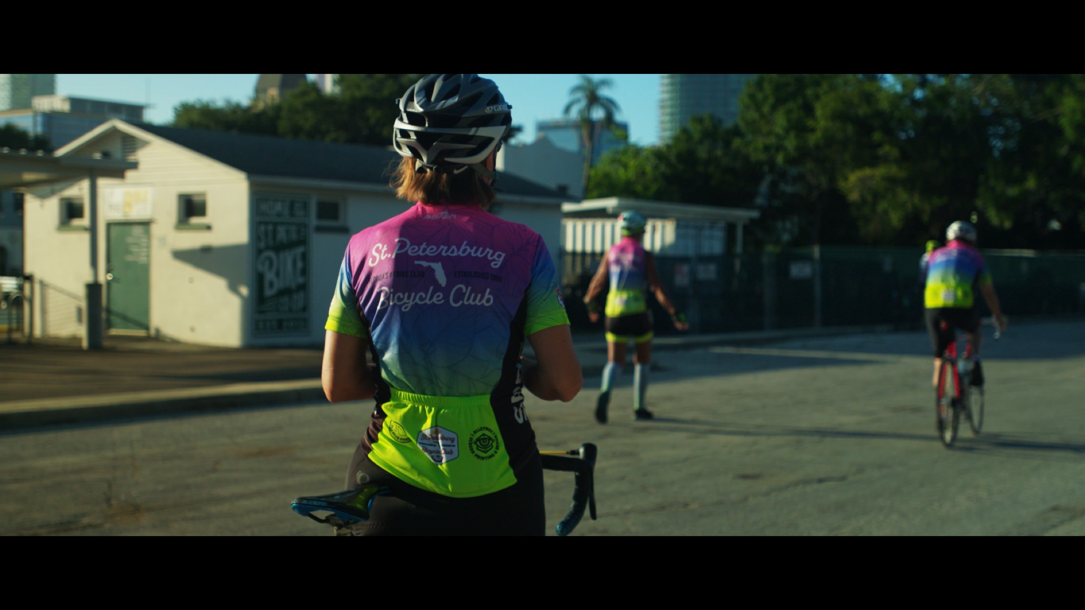 A group ride rolls through a city corridor in Florida.