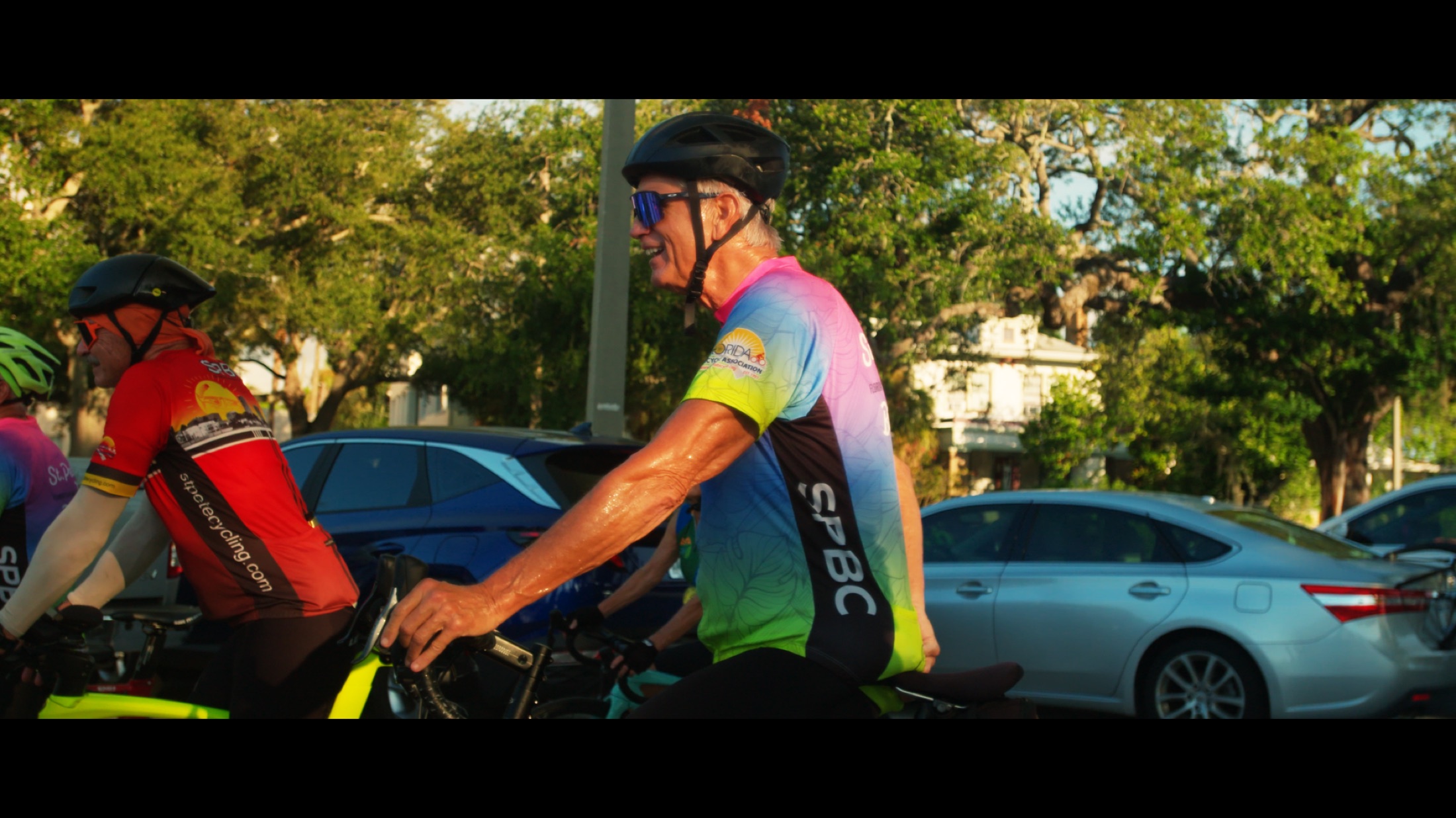 Cyclists navigate shared road space during the documentary.