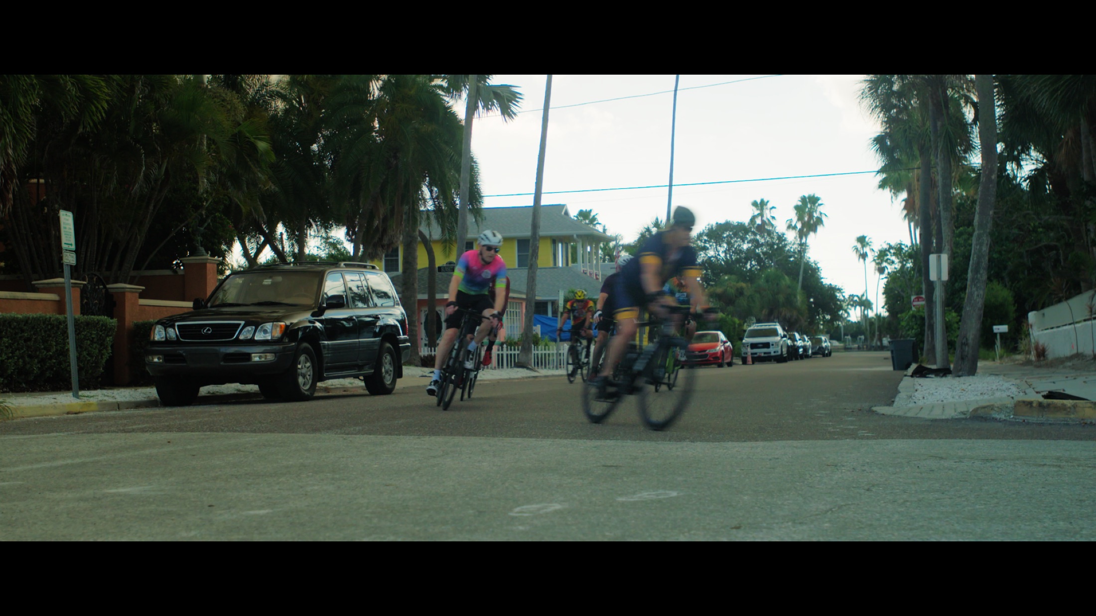 A group ride stretches along the road in the documentary.